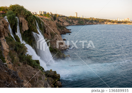 Majestic Waterfalls Cascading Into the Turquoise Sea at Sunset in Antalya, Showcasing Natures Beauty and the Tranquil Shoreline Majestic Waterfalls Cascading Into the Turquoise Sea at Sunset in Antalya, Showcasing Natures Beauty and the Tranquil Shoreline 136889935