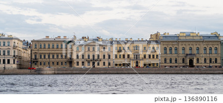 Historic Buildings Along the Neva River in St Petersburg Showcasing Classic Architecture and Urban Life During a Cloudy Day Historic Buildings Along the Neva River in St Petersburg Showcasing Classic Architecture and Urban Life During a Cloudy Day 136890116