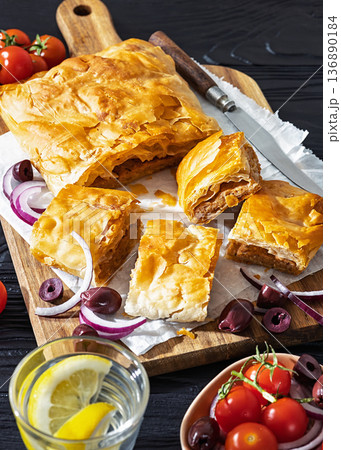 Greek savory sliced meat bougatsa pie with olives 136890184