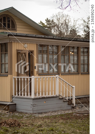 Charming Wooden House With a Welcoming Porch in a Serene Neighborhood During Late Afternoon 136890240