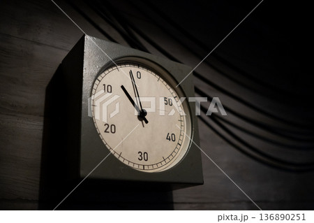 Clock Displaying Time Approaching Zero in a Dimly Lit Room Emphasizing Urgency and Anticipation During an Important Countdown 136890251
