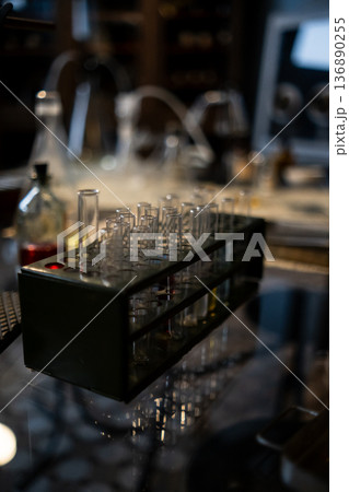 Laboratory Experiment With Glass Test Tubes and Equipment on a Reflective Surface During Evening Hours Laboratory Experiment With Glass Test Tubes and Equipment on a Reflective Surface During Evening Hours 136890255