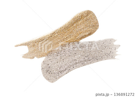 A sample of silver and gold nail polish with a shimmer and metallic effect. Isolated on a white background. A sample of silver and gold nail polish with a shimmer and metallic effect. Isolated on a white background. 136891272