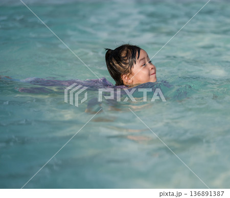 preschool child girl playing and swimming in pool preschool child girl playing and swimming in pool 136891387