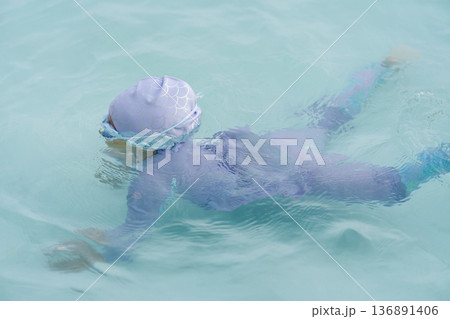 preschool child girl learning to diving in swimming pool preschool child girl learning to diving in swimming pool 136891406