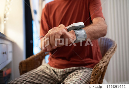 Senior man measuring blood pressure with wrist monitor. Senior man measuring blood pressure with wrist monitor. 136891431