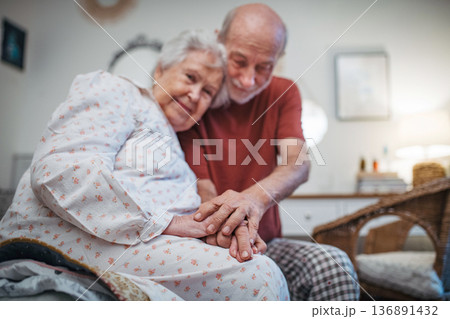 Elderly spouses sharing quiet moment before sleep. 136891432
