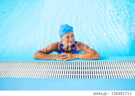 Elderly woman enjoying sport swimming for vitality and longevity. 136891711