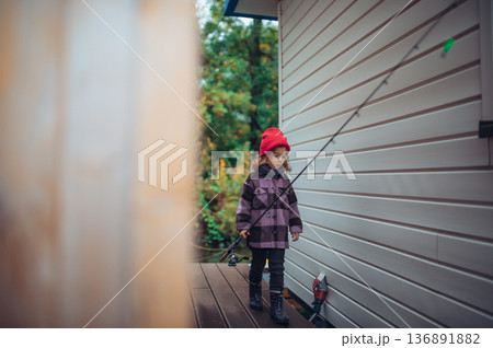 Girl going on fishing trip, wearing rubber boots. Girl going on fishing trip, wearing rubber boots. 136891882