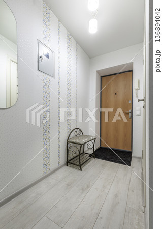 Hallway Interior with Decorative Bench and Patterned Wallpaper 136894042