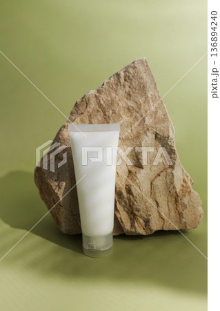 Cosmetic cream tubes on natural stone with soft green background, clean skincare packaging mockup for beauty, wellness, organic products and minimalist branding. Cosmetic cream tubes on natural stone with soft green background, clean skincare packaging mockup for beauty, wellness, organic products and minimalist branding. 136894240