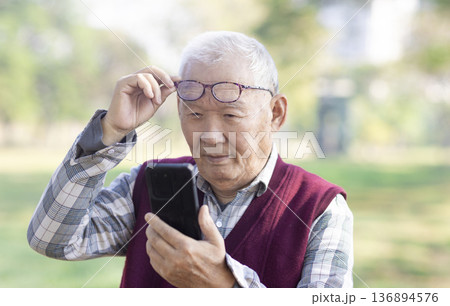 Poor Eyesight. Senior Man Using Smartphone Wearing Eyeglasses Poor Eyesight. Senior Man Using Smartphone Wearing Eyeglasses 136894576