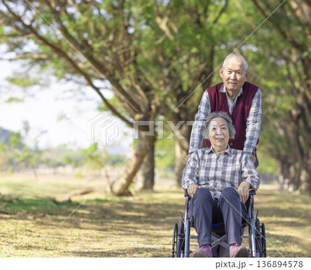 Asian senior or elderly old lady woman patient on wheelchair in park Asian senior or elderly old lady woman patient on wheelchair in park 136894578
