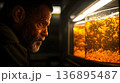 Intense gaze of a man observing bubbling amber liquid in illumin 136895487