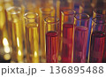 Closeup of Test Tubes with Vibrant Yellow and Crimson Liquids 136895488