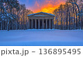 Winter Sunset Illuminates Classical Temple Amidst Snow-Covered F 136895495