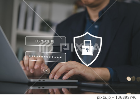 Businessman hand typing laptop, secure login password. Cybersecurity technology concept. Data protection, privacy, network access, shield icon. Account authentication, corporate safety system. 136895746