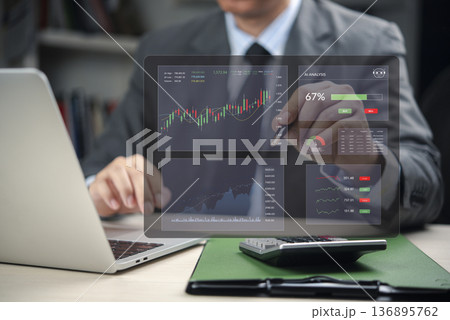 Businessman in office use FinTech dashboard. AI analysis stock trading data. Virtual screen show financial growth chart. Investment technology strategy, corporate business solution. 136895762