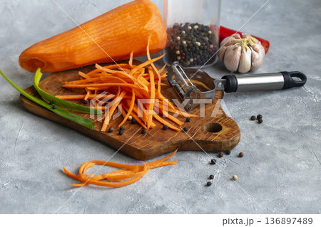 Ingredients for carrot and green onion salad. Vegetable cutting process. 136897489