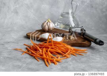 Ingredients for carrot and green onion salad. Vegetable cutting process. 136897493