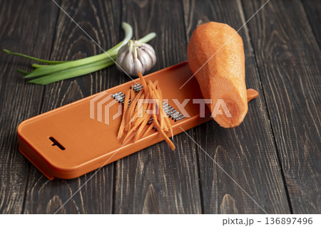 Ingredients for carrot and green onion salad. Vegetable cutting process. Ingredients for carrot and green onion salad. Vegetable cutting process. 136897496