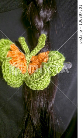 Butterflies made of colored yarn, crocheted on a dark surface. Handmade. 136897501