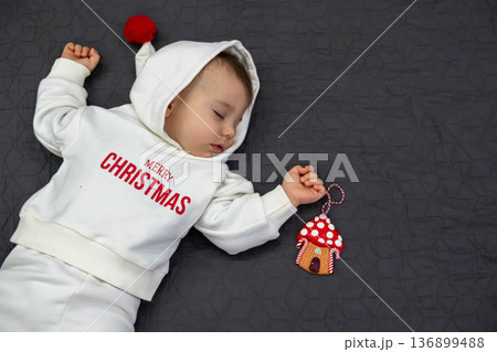 Sleeping Baby in Christmas Outfit 136899488
