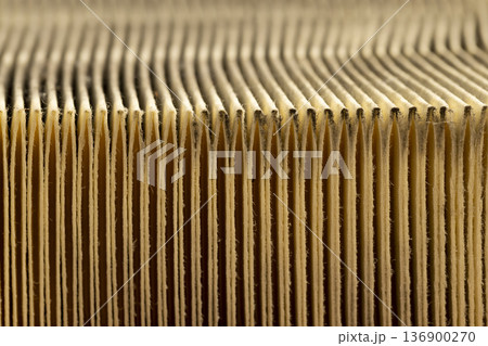 an old filter for cleaning the air in the car, a dirty and long-used paper filter for cleaning the air in the car engine 136900270