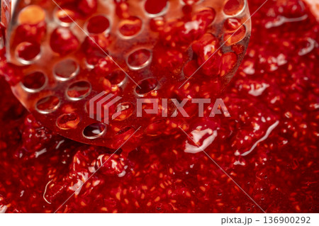 juicy red fresh grated strawberries in a bowl, making a sweet delicious and juicy dessert from natural berries, a large bowl with grated ripe strawberries while making desserts 136900292