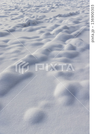 details a lot of small snowdrifts of white color, soft and fluffy fallen snow in the winter season in sunny weather, the structure of snow after a snowfall details a lot of small snowdrifts of white color, soft and fluffy fallen snow in the winter season in sunny weather, the structure of snow after a snowfall 136900303