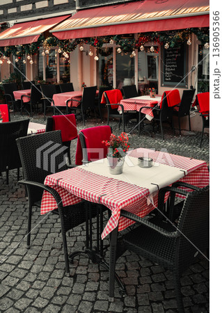 Cozy Outdoor Cafe Tables with Checkered Tablecloths 136905366