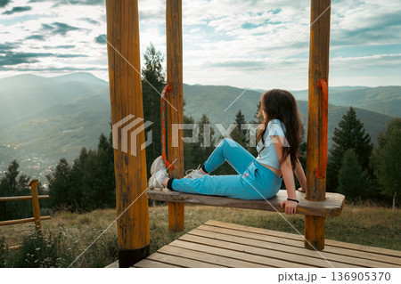 Woman Enjoying Mountain Landscape at Scenic Viewpoint Woman Enjoying Mountain Landscape at Scenic Viewpoint 136905370