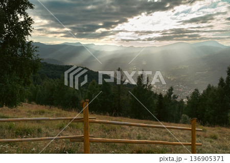 Sun Rays Over Mountain Valley at Sunset 136905371