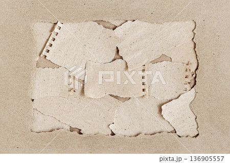 Torn recycled paper sheets framed by kraft cardboard, layered paper texture composition. Natural background of recycled paper texture for eco design, mockup, copy space Torn recycled paper sheets framed by kraft cardboard, layered paper texture composition. Natural background of recycled paper texture for eco design, mockup, copy space 136905557