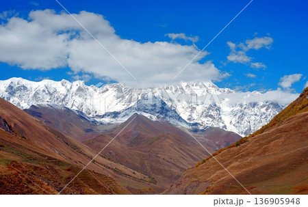 A trekking trail to the Shkhara Glacier from Ushguli. An autumn valley in the Caucasus Mountains. A trekking trail to the Shkhara Glacier from Ushguli. An autumn valley in the Caucasus Mountains. 136905948