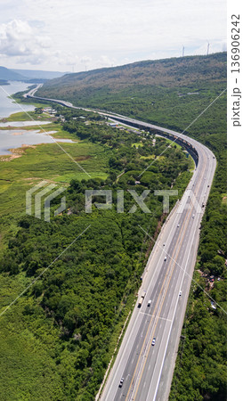 Drone shot The M6 motorway Nakhon Ratchasima Province - Bang Pa-in Lam Ta Khong River and Mountain. Motorway Korat Thailand Drone shot The M6 motorway Nakhon Ratchasima Province - Bang Pa-in Lam Ta Khong River and Mountain. Motorway Korat Thailand 136906242