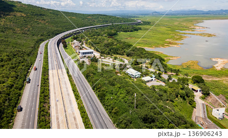 Drone shot The M6 motorway Nakhon Ratchasima Province - Bang Pa-in Lam Ta Khong River and Mountain. Motorway Korat Thailand 136906243