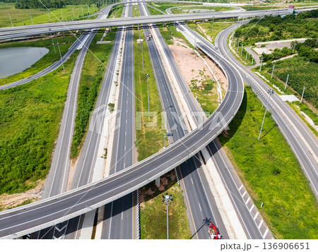 Drone shot a large highway interchange crossing over green farmlands in Thailand Drone shot a large highway interchange crossing over green farmlands in Thailand 136906651