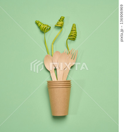 Paper cups and wooden forks and spoon, long green decorative branches, Paper cups and wooden forks and spoon, long green decorative branches, 136906969