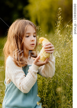 Lovely girl cuddling baby duckling. Lovely girl cuddling baby duckling. 136908880
