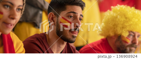 Worried football fans supporting spanish national team in live soccer match at stadium. Worried football fans supporting spanish national team in live soccer match at stadium. 136908924