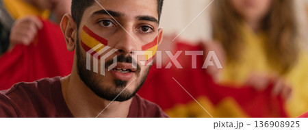 Excited football fans supporting spanish national team in live soccer match at stadium. Excited football fans supporting spanish national team in live soccer match at stadium. 136908925