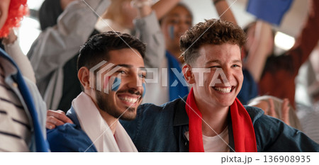 French football fans celebrating their team's victory at stadium. 136908935