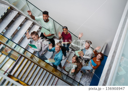 Group of university students walking up stairs, back to school concept. Group of university students walking up stairs, back to school concept. 136908947