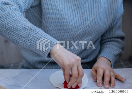 Workshop cutting figures Creator is using white air dry clay for making decor to Christmas tree holiday. Creating hobby recreation activity that involves fingers. DIY crafting 136909965