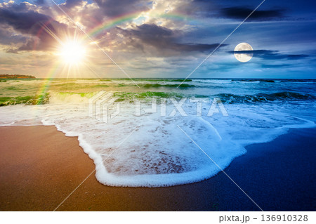tide rolling on the sandy beach. day meet night. sun and moon over sea waves on a cloudy sky at twilight. empty calm scenery on autumn equinox. generic image for astrology wallpaper or book cover use tide rolling on the sandy beach. day meet night. sun and moon over sea waves on a cloudy sky at twilight. empty calm scenery on autumn equinox. generic image for astrology wallpaper or book cover use 136910328