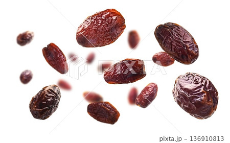Dried dates levitate on a white background 136910813