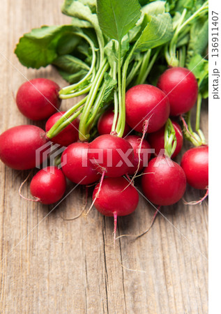 Fresh radishes bunch on rustic wooden table Fresh radishes bunch on rustic wooden table 136911407