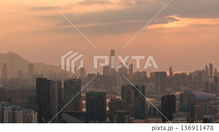 Hazy Kowloon skyline glowing under warm sunset Feb 19 2026 Hazy Kowloon skyline glowing under warm sunset Feb 19 2026 136911478