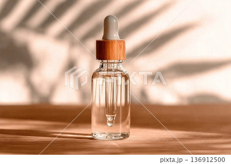 Natural oil cosmetics. Dropper glass Bottle Mock-Up. Oily cosmetic pipette. Face and body treatment. Spa concept. Mineral organic liquid. Front view. Beauty products. Blank packaging on wooden table. 136912500